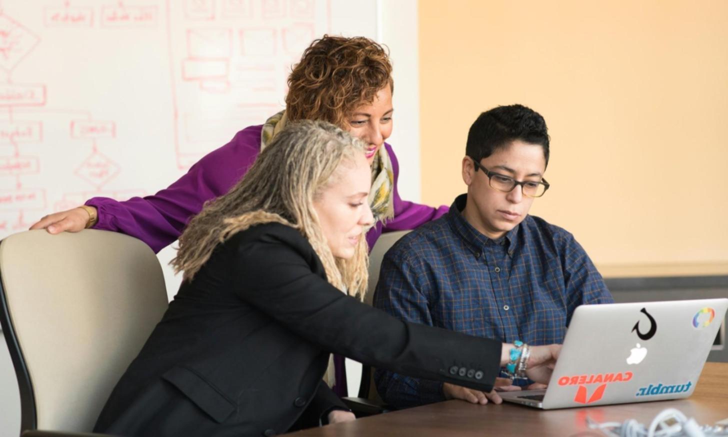 Team reviewing mobile application specifications and user flow diagrams